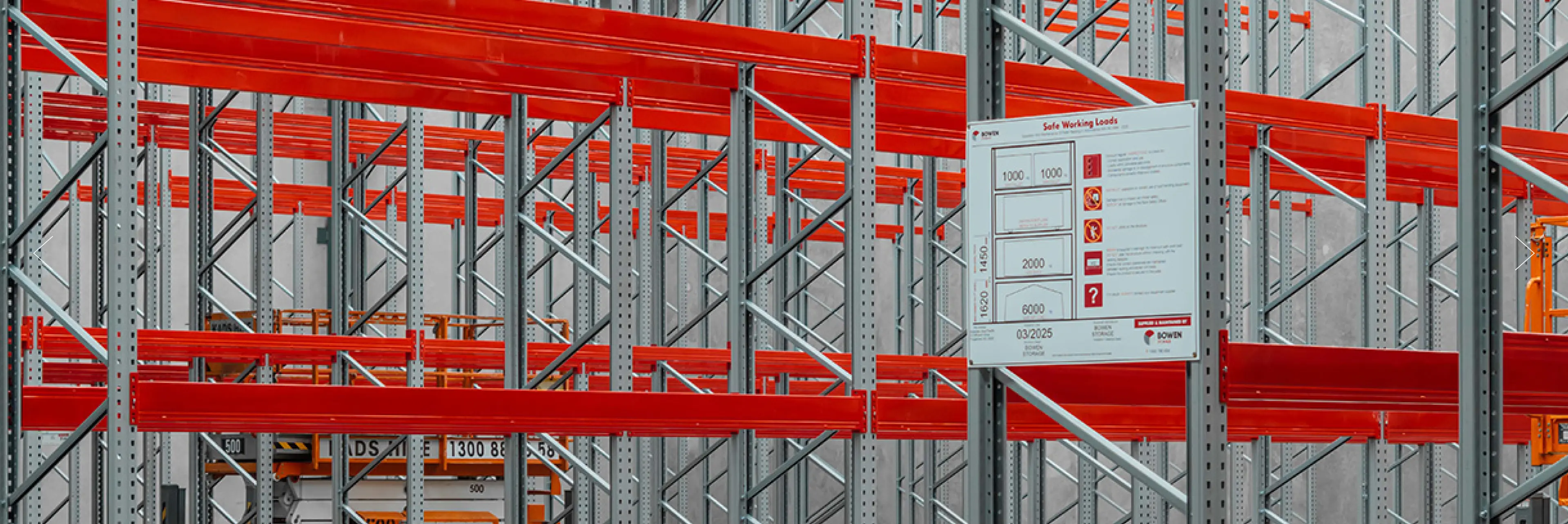 Warehouse pallet racking filled with boxed inventory and labelled storage bays