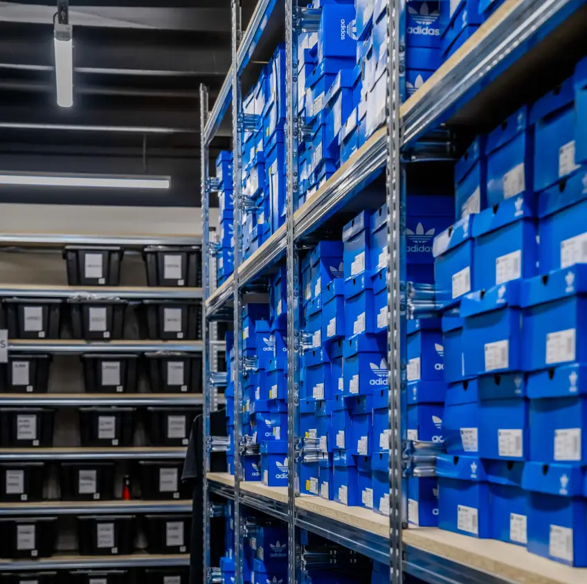 warehouse shelving system with stacked shoe boxes in organized rows