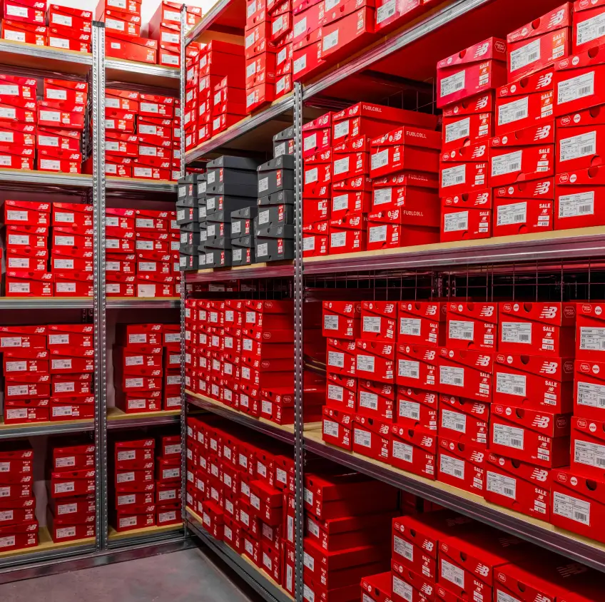 Warehouse shelving filled with boxed inventory for retail distribution