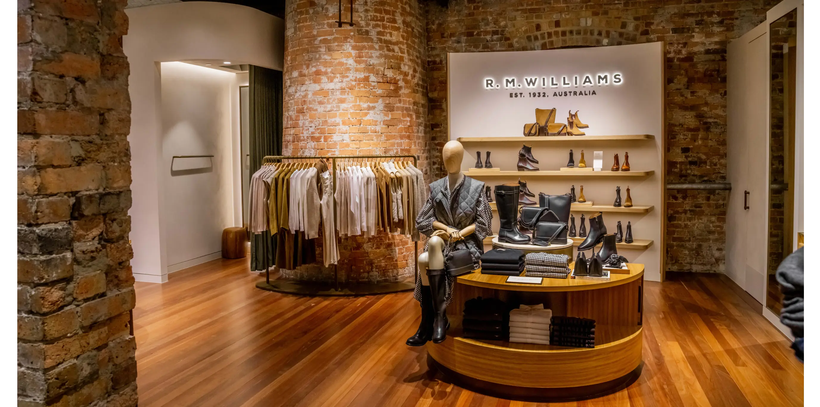 Retail clothing store fitout with timber flooring, product displays, and branded shelving layout