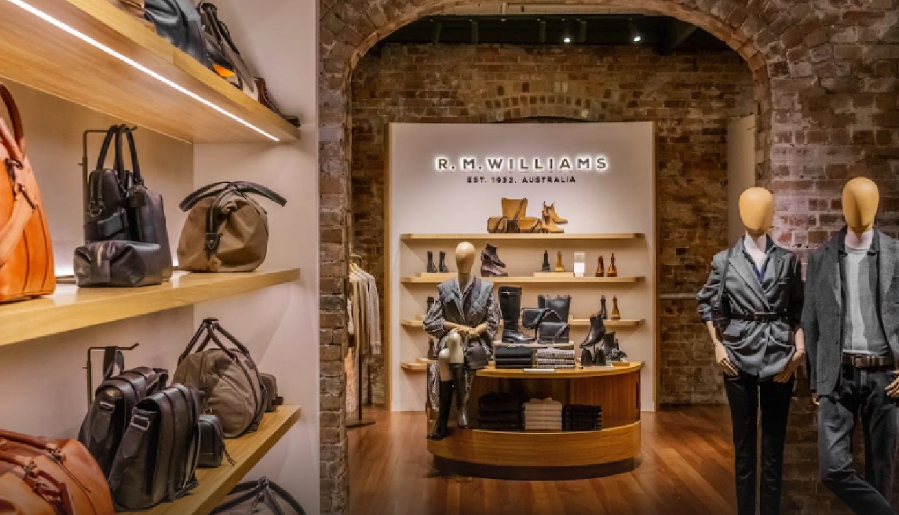R.M. Williams retail store interior with leather goods, footwear displays, and heritage brick design