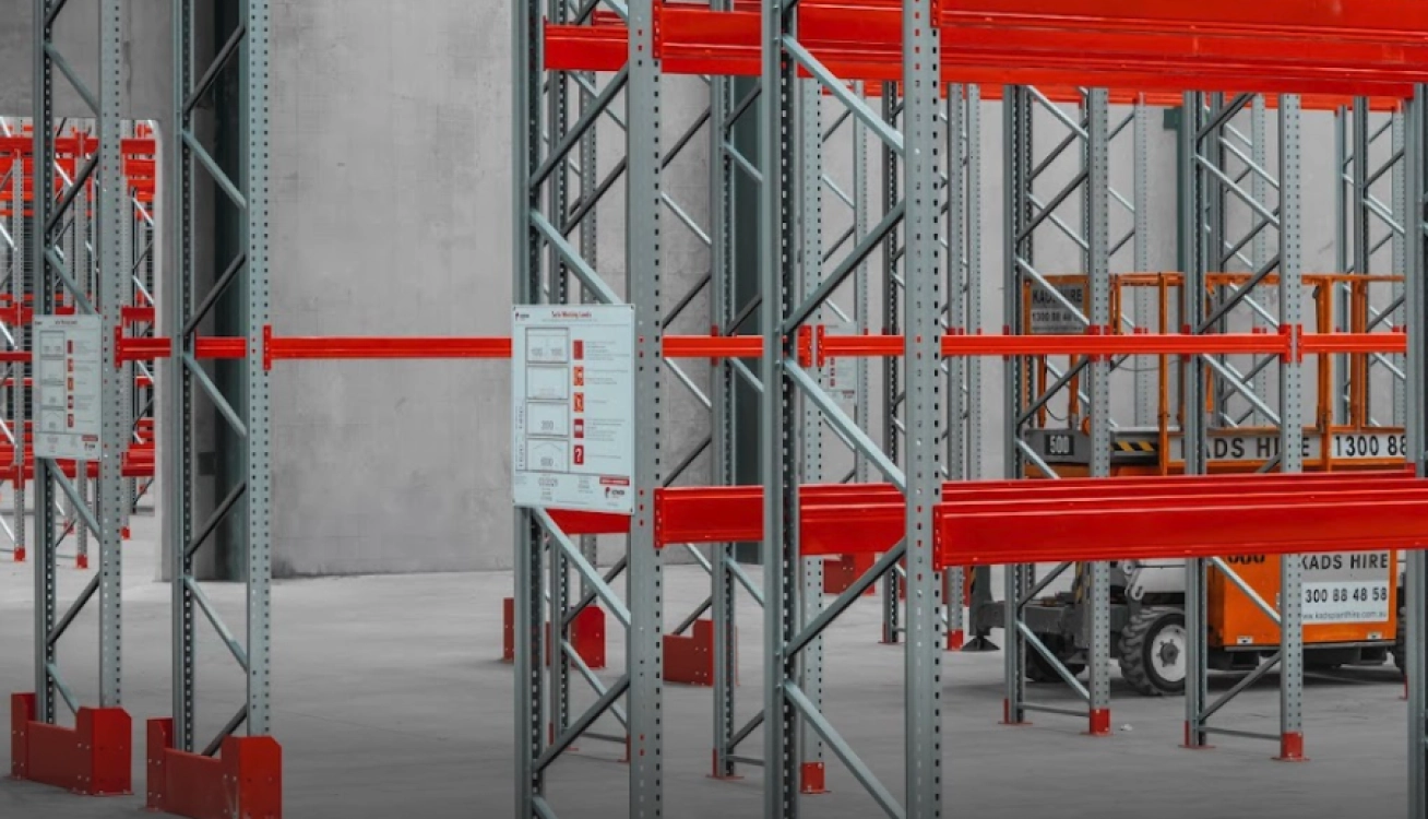 Industrial racking system with upright frames and beam installation for warehouse storage solutions