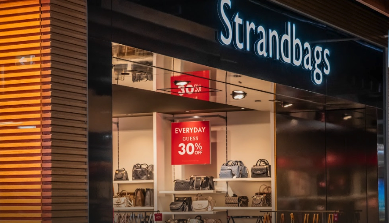 Strandbags retail storefront with luggage display and promotional sale signage