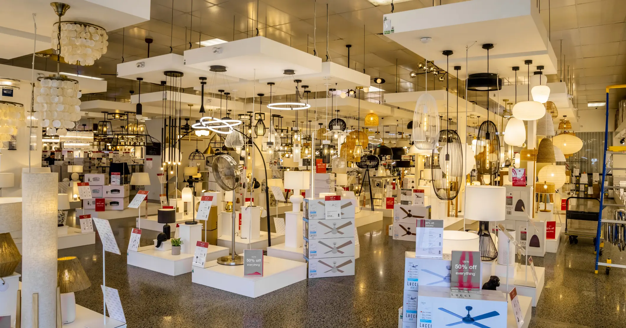 Retail lighting showroom fitout with display stands, ceiling lights, and organised product layout