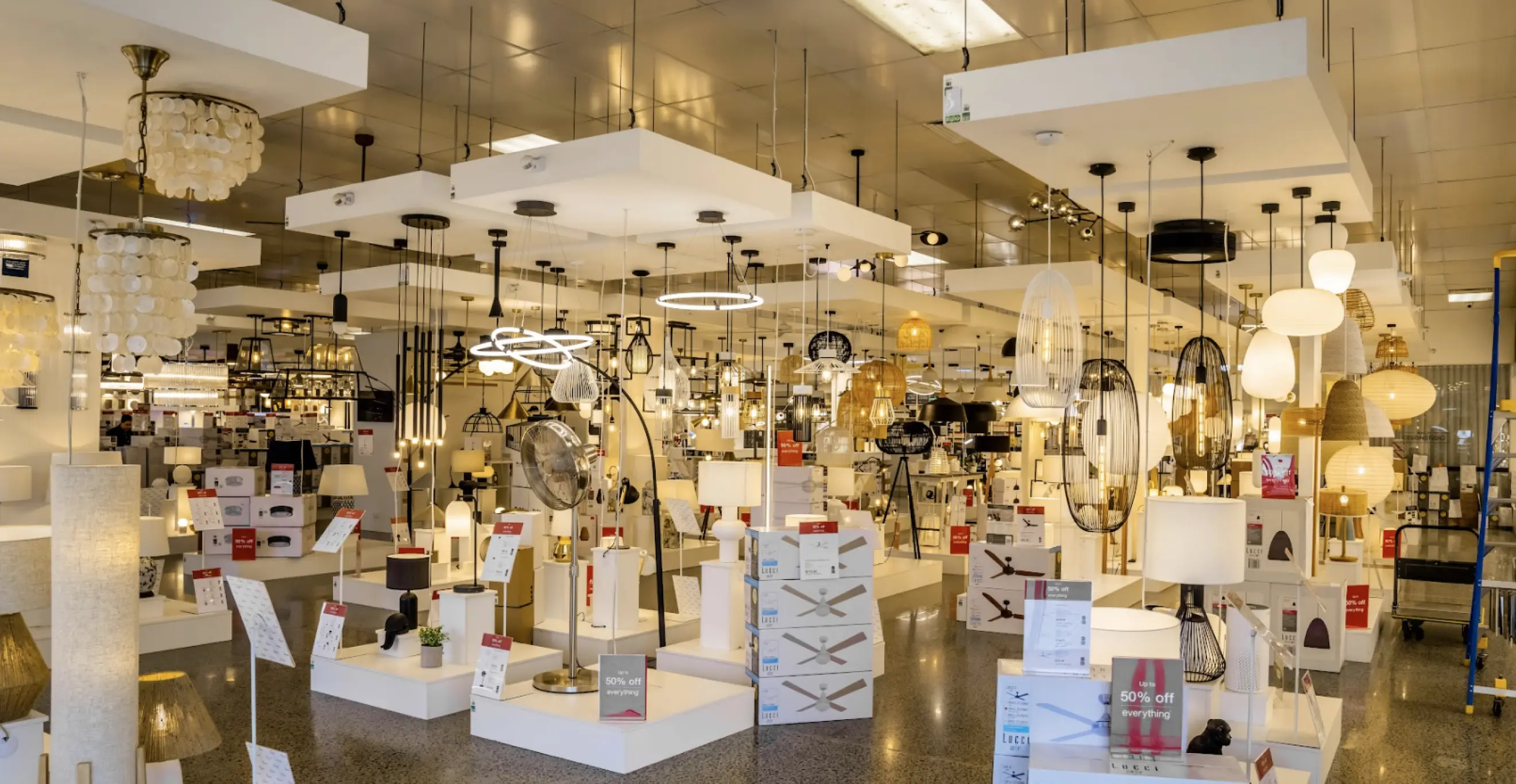 Retail lighting showroom fitout with display stands, ceiling lights, and organised product layout
