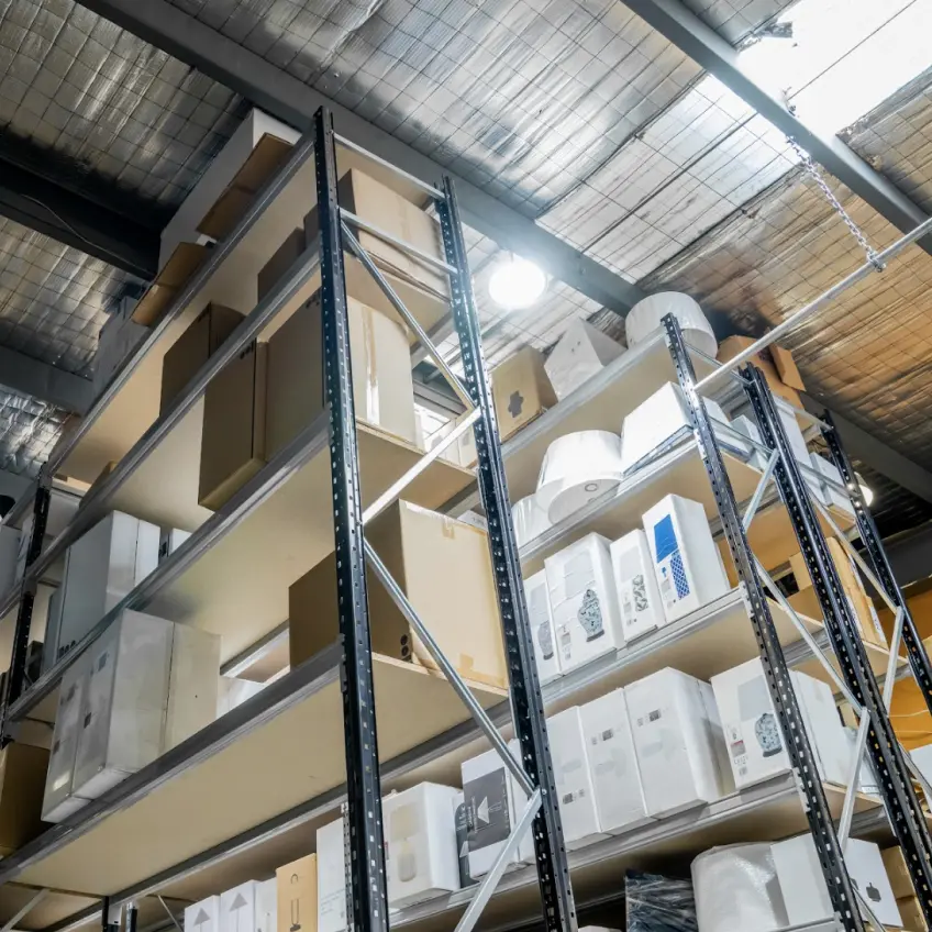 High-density warehouse shelving system storing small boxed goods for fast picking operations