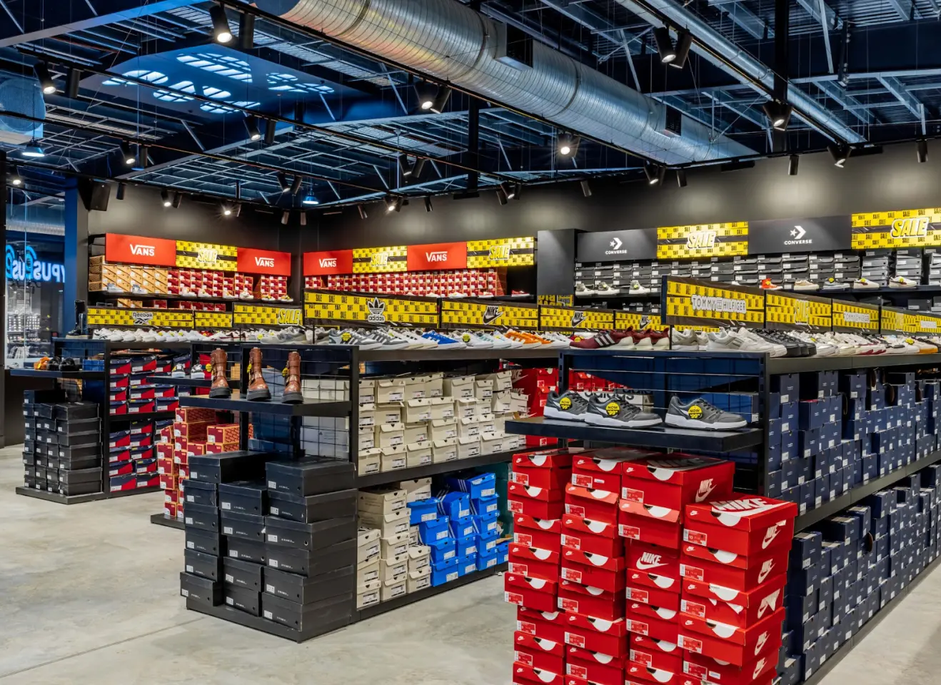 Retail shoe store interior with shelving, display units, and organised footwear product layout