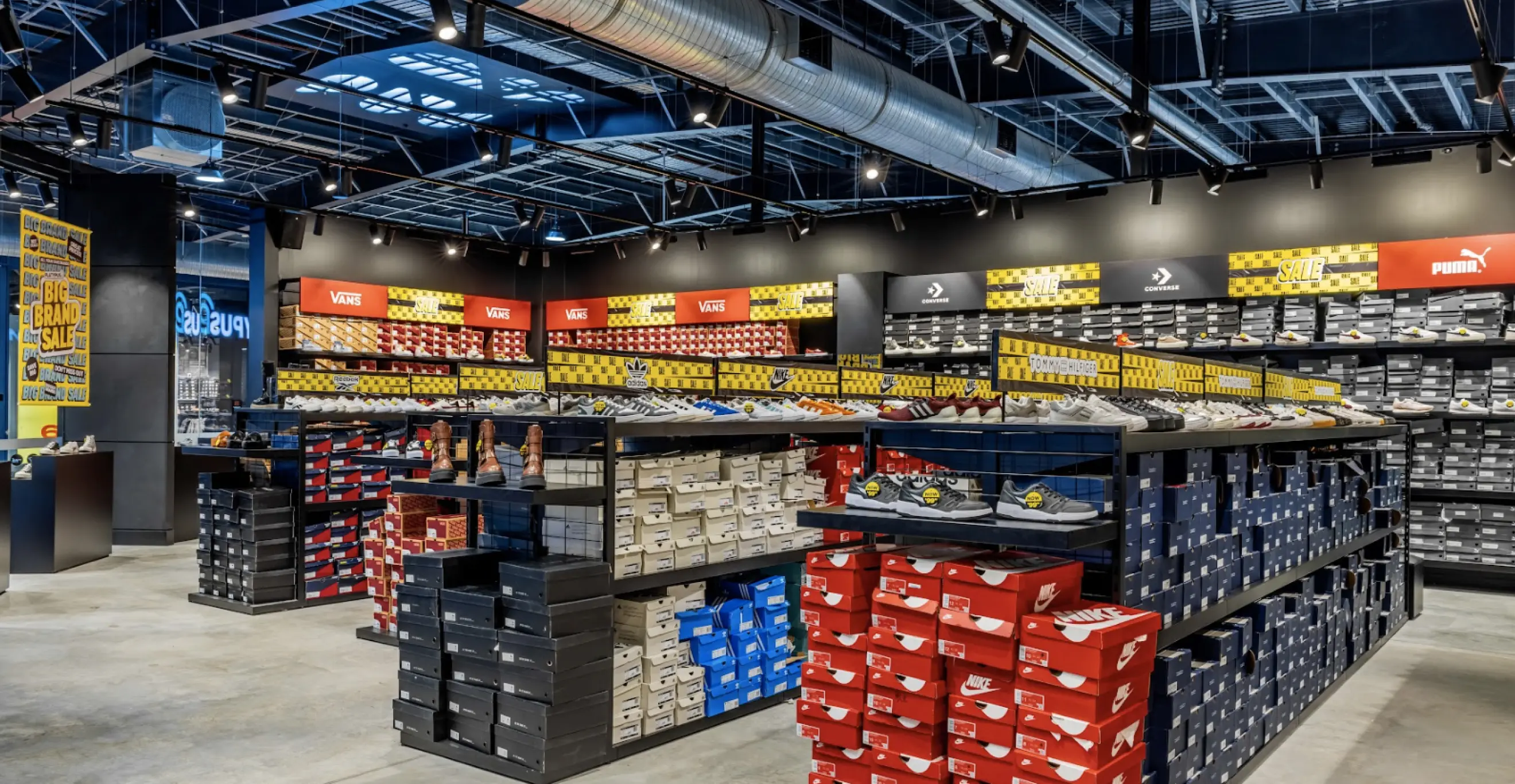 Retail shoe store interior with shelving, display units, and organised footwear product layout