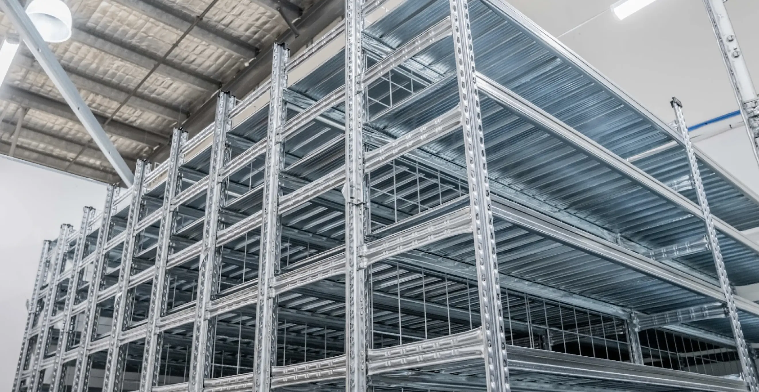 Industrial shelving units with mesh panels and integrated bin storage for warehouse use