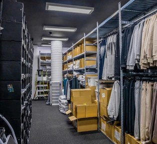 Elite Eleven activewear stockroom with pigeonhole storage, hanging garments and staff workstation