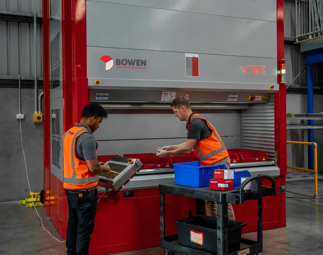 Vertical lift storage system (VLM) with operators retrieving items from automated unit